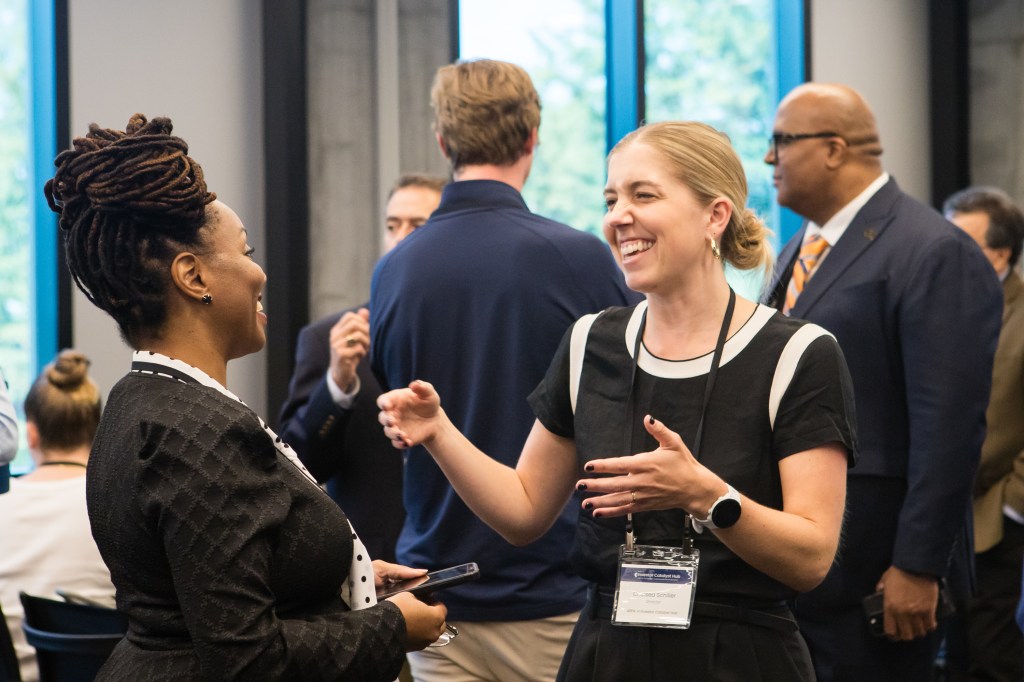Investor Catalyst Hub Director Chelsea Schiller networks with event attendees.